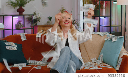Money cash rain falling on senior old grandmother woman celebrating success, winning, achievement Money cash rain falling on senior old grandmother woman celebrating success, winning, achievement 93589638