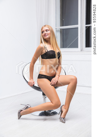 Charming young woman wearing lingerie Charming young woman wearing lingerie 93594828