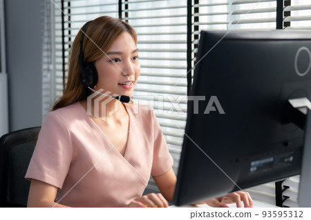 Competent female operator working on computer... - Stock Photo ...