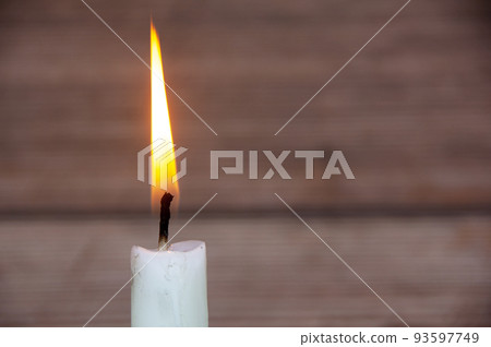 Candle light burning brightly with customizable space for text or ideas. Copy space 93597749