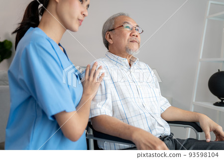 Caring nurse and a contented senior man in a wheel chair at home. Caring nurse and a contented senior man in a wheel chair at home. 93598104