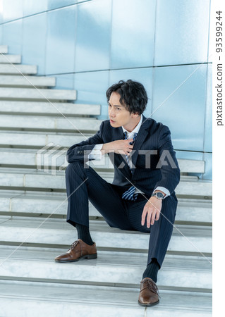 Angry office worker sitting on the stairs Angry office worker sitting on the stairs 93599244