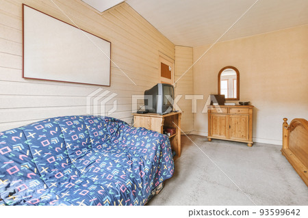 Home interior design of bedroom with bed and wooden wardrobe placed in corner near window in modern apartment Home interior design of bedroom with bed and wooden wardrobe placed in corner near window in modern apartment 93599642