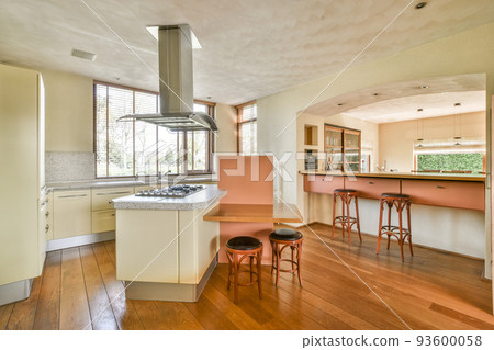 Interior of modern room illuminated with sunlight from ceiling window and door in modern house Interior of modern room illuminated with sunlight from ceiling window and door in modern house 93600058