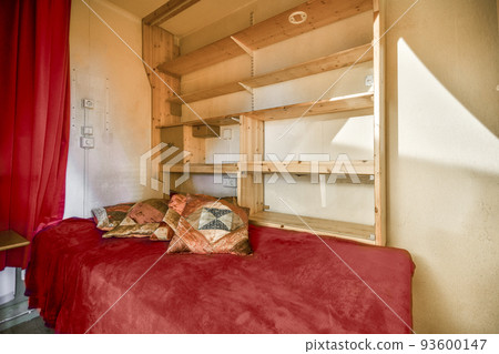 Table with chairs and flowers located near lounge area and kitchen in spacious room of contemporary apartment Table with chairs and flowers located near lounge area and kitchen in spacious room of contemporary apartment 93600147