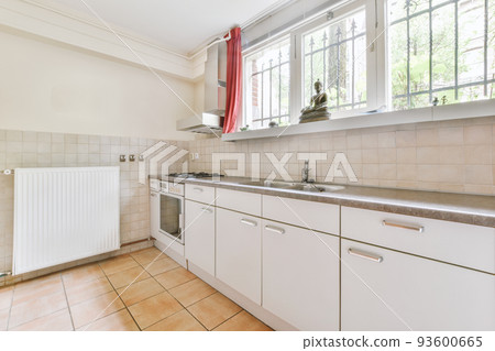 Home interior design of modern loft apartment with open kitchen in minimalist style and spacious dining zone with table and chairs Home interior design of modern loft apartment with open kitchen in minimalist style and spacious dining zone with table and chairs 93600665