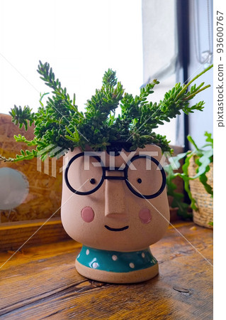 Beautiful ceramic planter with homemade flowers on the table. Beautiful ceramic planter with homemade flowers on the table. 93600767