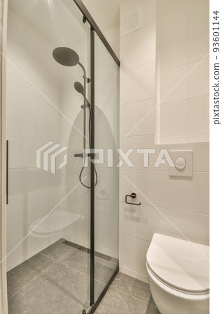 Stylish bathroom interior design with white toilet and shower cabin with glass shower in modern apartment Stylish bathroom interior design with white toilet and shower cabin with glass shower in modern apartment 93601144