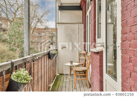 Front view of old brick buildings and cars with bicycles from small balcony with railings Front view of old brick buildings and cars with bicycles from small balcony with railings 93601150