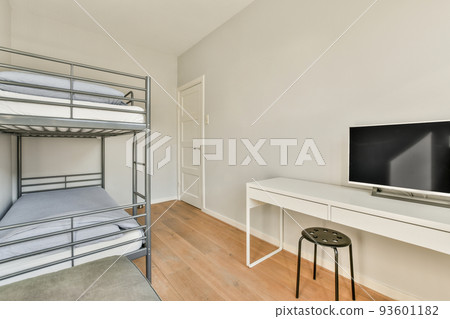 Comfortable bed and chairs located in near wall with framed painting in contemporary bedroom at home 93601182