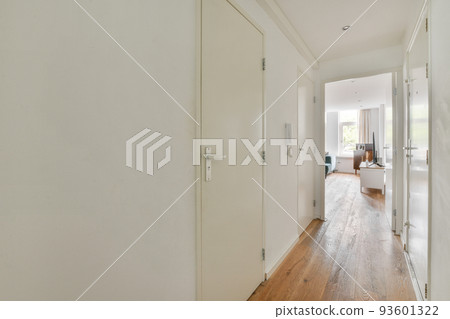Light narrow hallway with many doors in white walls and glowing lamp over lumber floor Light narrow hallway with many doors in white walls and glowing lamp over lumber floor 93601322