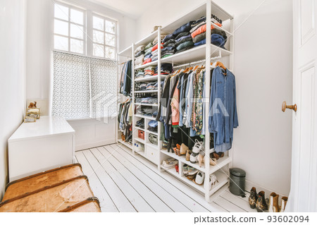 White wardrobe with mirrors located near guitar and cabinet in light room at home White wardrobe with mirrors located near guitar and cabinet in light room at home 93602094