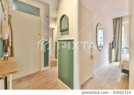 Corridor of contemporary apartment with doorway leading to terrace 93602314