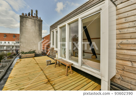 Open plan studio apartment with triangle shaped roof and construction of wooden beams in daylight 93602390