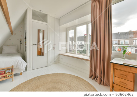 Comfortable bed placed near green wall in modern minimalist style mansard bedroom with windows Comfortable bed placed near green wall in modern minimalist style mansard bedroom with windows 93602462