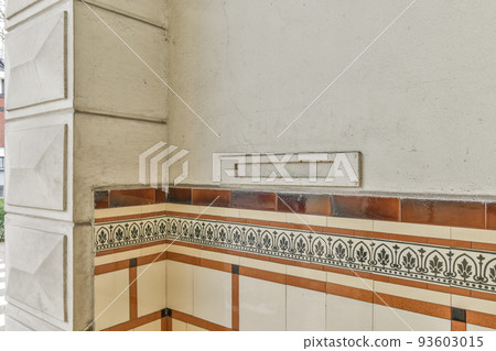 From below classic plaster floral ornament of medallion decorating ceiling above elegant chandelier at home 93603015