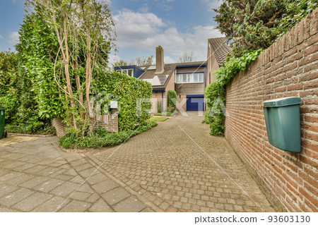 Neat paved patio with sitting area and small garden near wooden fence Neat paved patio with sitting area and small garden near wooden fence 93603130