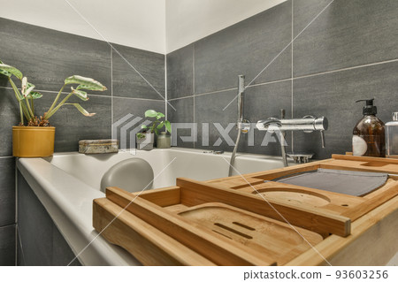 White bathtub with metal faucet in modern bathroom in minimal style in apartment White bathtub with metal faucet in modern bathroom in minimal style in apartment 93603256