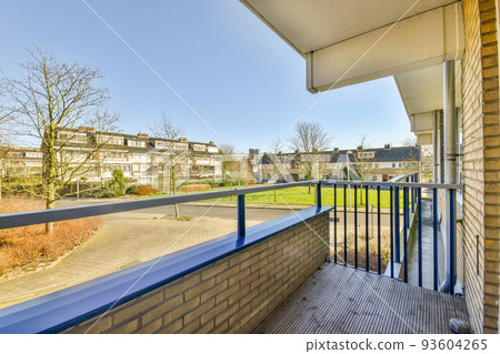 Narrow brick balcony with metal railings and door Narrow brick balcony with metal railings and door 93604265