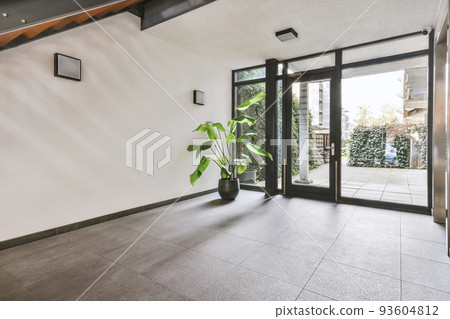 Perspective view of empty narrow hallway with white walls parquet floor in minimalist style apartment 93604812