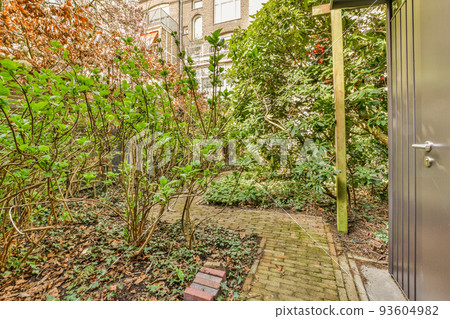 Simple small patio with small garden near wooden fence 93604982