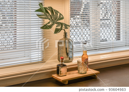 Simple small patio with small garden near wooden fence 93604983