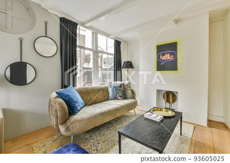 Comfortable sofa and placed on soft carpet near windows in cozy light living room in modern flat Comfortable sofa and placed on soft carpet near windows in cozy light living room in modern flat 93605025