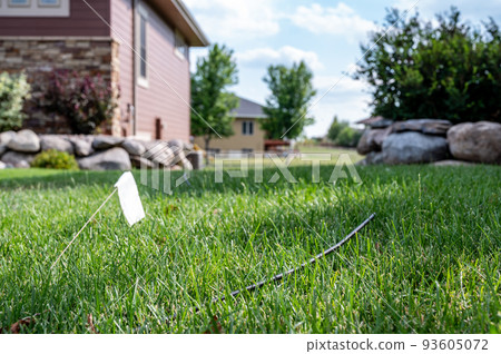 Fiber optic cable laying in the grass ready to be installed at a residential house. Fiber optic cable laying in the grass ready to be installed at a residential house. 93605072