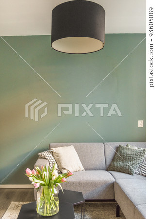 Studio apartment with white walls and open plan kitchen and dining zone with sofa in living room 93605089