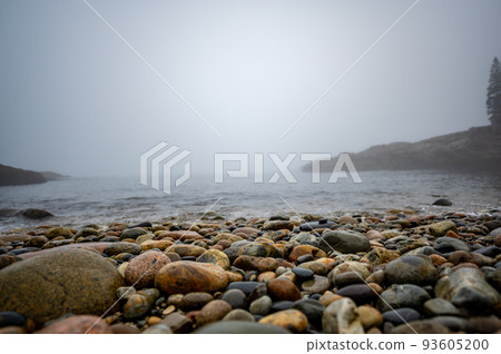 Multi-colored round rocks on Little Hunters Beach in Acadia National Park, Maine. Tide coming in as waves crash. Multi-colored round rocks on Little Hunters Beach in Acadia National Park, Maine. Tide coming in as waves crash. 93605200