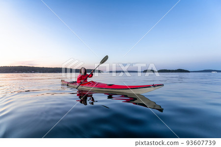 Adventurous Woman on Sea Kayak paddling in the Pacific Ocean Adventurous Woman on Sea Kayak paddling in the Pacific Ocean 93607739