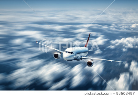 Airplane is flying above the low clouds in summer 93608497