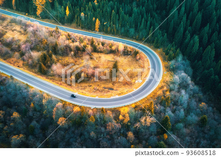 Aerial view of mountain road in forest at sunset in autumn 93608518