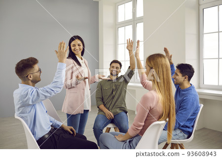 Smiling employees raise hands participate in voting 93608943
