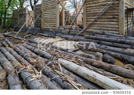 traditional wooden house peeled log wall during cobntruction process with diagonal props traditional wooden house peeled log wall during cobntruction process with diagonal props 93609358