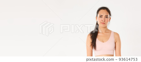 Sport, wellbeing and active lifestyle concept. Skeptical and displeased asian sportswoman, female athlete smirk disappointed and unamused, looking left with frowning face, white background Sport, wellbeing and active lifestyle concept. Skeptical and displeased asian sportswoman, female athlete smirk disappointed and unamused, looking left with frowning face, white background 93614753