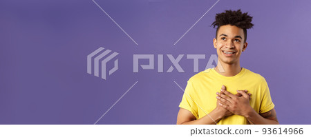 Close-up portrait of touched, romantic attractive man, hold hands on heart, remember nice lovely memory, looking up daydreaming, smiling pleased, appreciate something, purple background Close-up portrait of touched, romantic attractive man, hold hands on heart, remember nice lovely memory, looking up daydreaming, smiling pleased, appreciate something, purple background 93614966