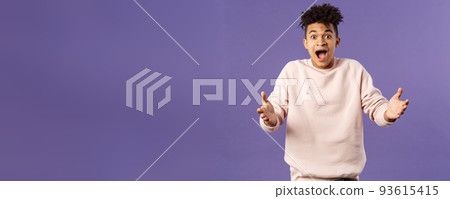 Portrait of surprised happy young man reaching hands to hug friend seeing him on street, rejoicing over big great news, standing impressed and thrilled over purple background Portrait of surprised happy young man reaching hands to hug friend seeing him on street, rejoicing over big great news, standing impressed and thrilled over purple background 93615415