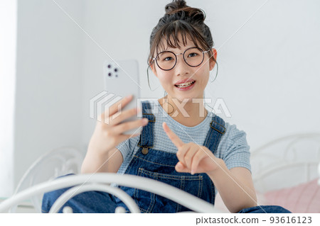 High school girl operating a smartphone 93616123