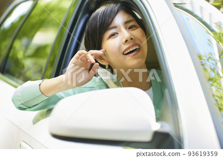 A young woman driving a car A young woman driving a car 93619359
