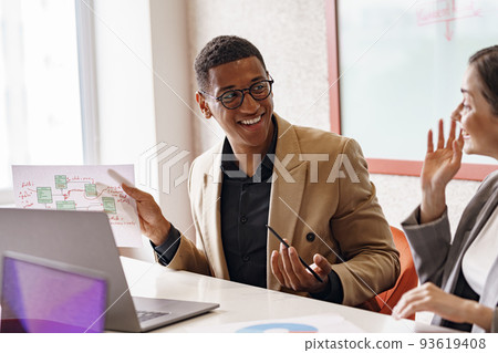 Smiling coworkers cooperating and working together at coworking space, teamwork concept 93619408