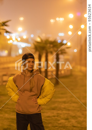 Woman on the background of the night foggy city. Selective focus. 93623634