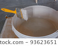 the paint brush is fixed in a bucket above the paint.construction works, 93623651
