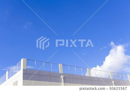 Blue sky and rooftop of commercial facility 93625567