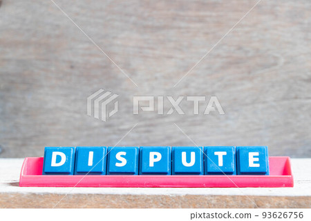 Tile alphabet letter with word dispute in red color rack on wood background Tile alphabet letter with word dispute in red color rack on wood background 93626756