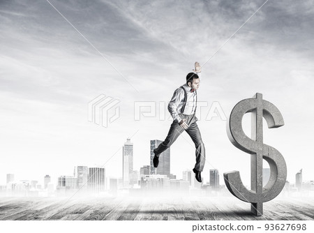 Determined banker man against modern cityscape breaking dollar concrete figure 93627698