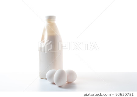 Bottle of milk and chicken eggs on a white background. Dairy products on a white background. 93630781