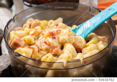 Macro photo of pasta dish with sauce and vegetables. Tourist food in tourist dishes. Macro photo of pasta dish with sauce and vegetables. Tourist food in tourist dishes. 93630782
