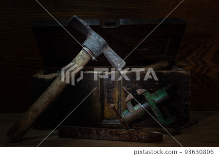 Hammer pick and vise. Construction and turning tools. Composition in a low key. Vintage still life. Hammer pick and vise. Construction and turning tools. Composition in a low key. Vintage still life. 93630806
