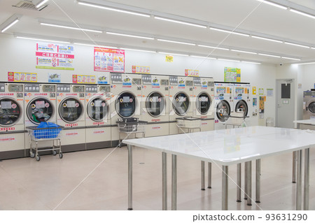 Washing machines lined up in a coin laundry Washing machines lined up in a coin laundry 93631290